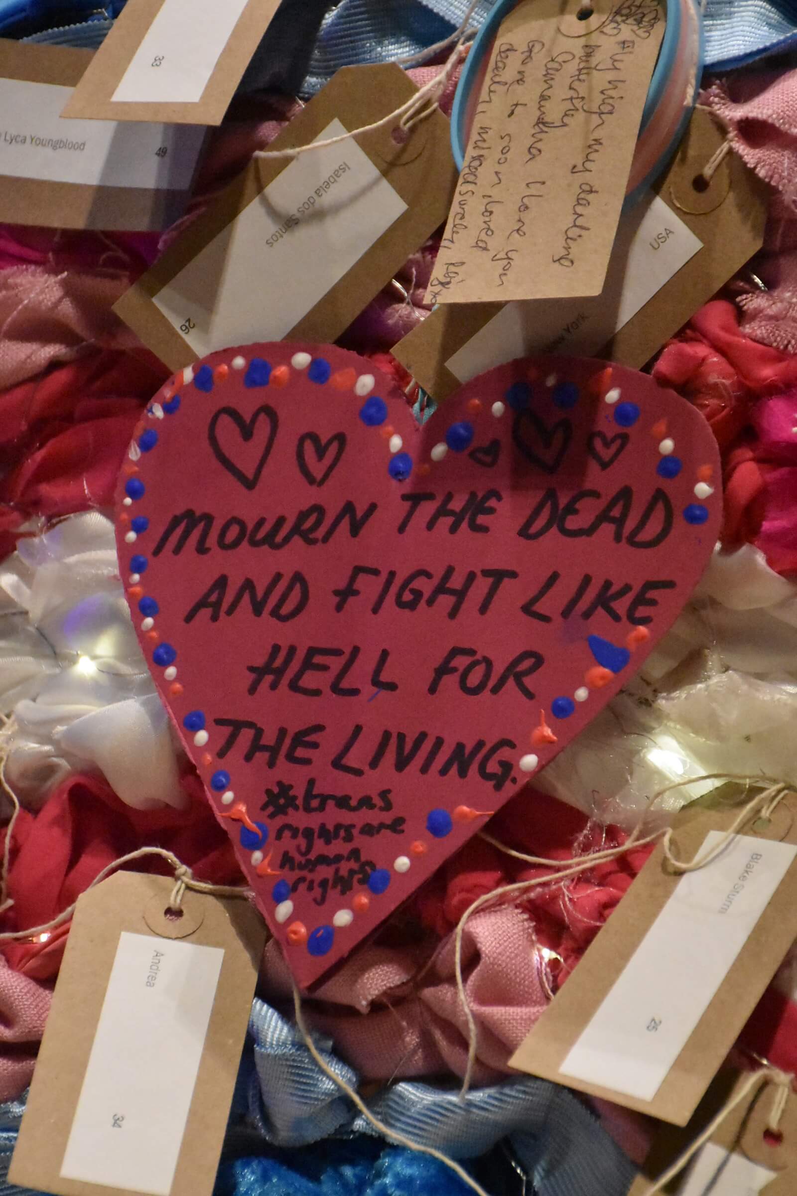 A heart shape note that says 'mourn the dead and fight like hell for the living #transrightsarehumanrights'