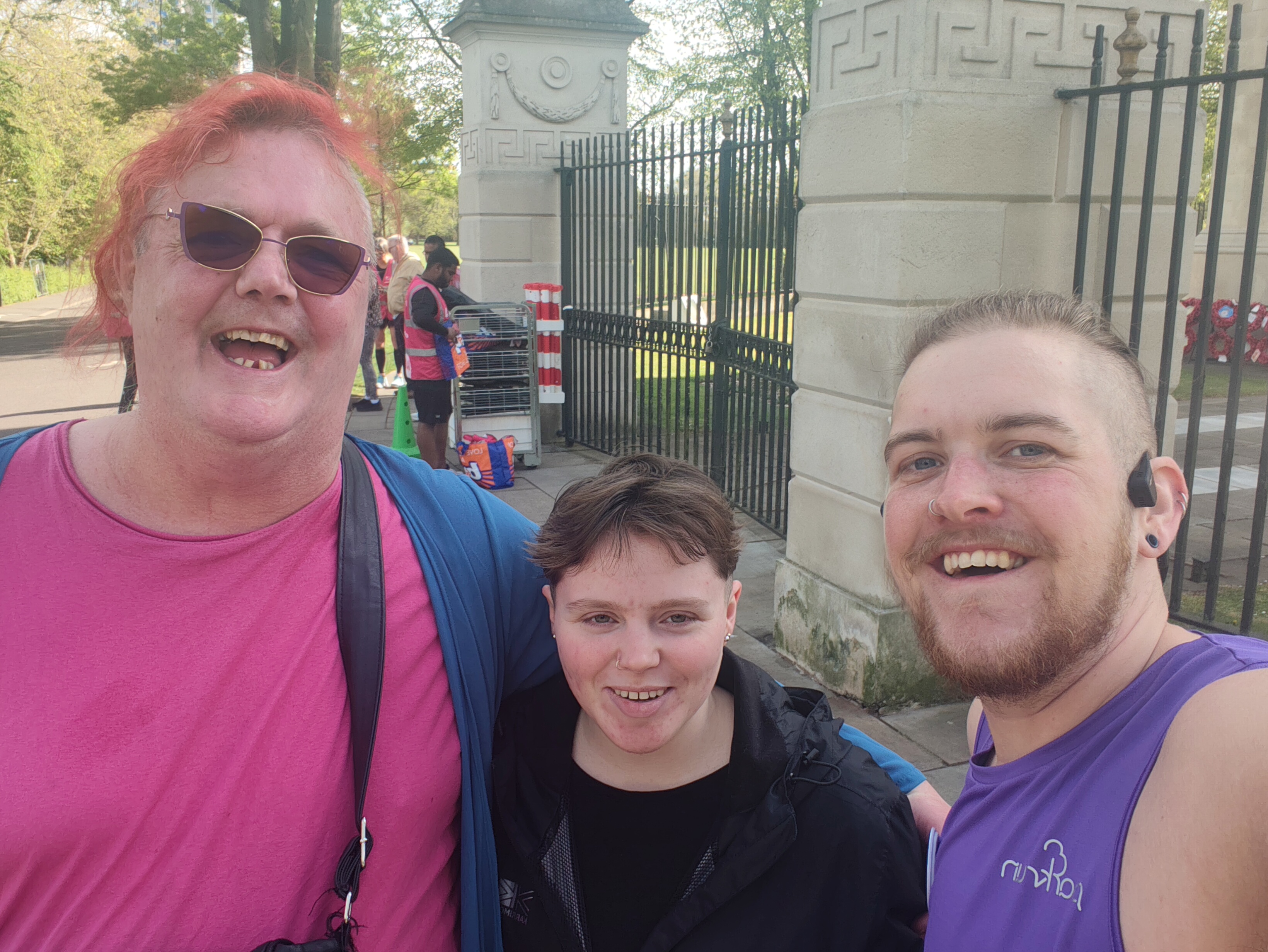 Three people together smiling and looking joyful.